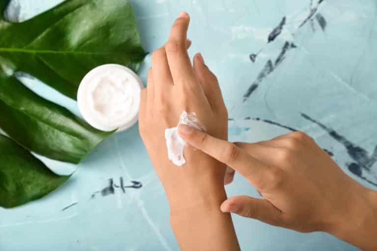 Woman applying hand cream
